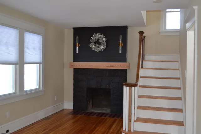 a living room with a fireplace and a wooden floor