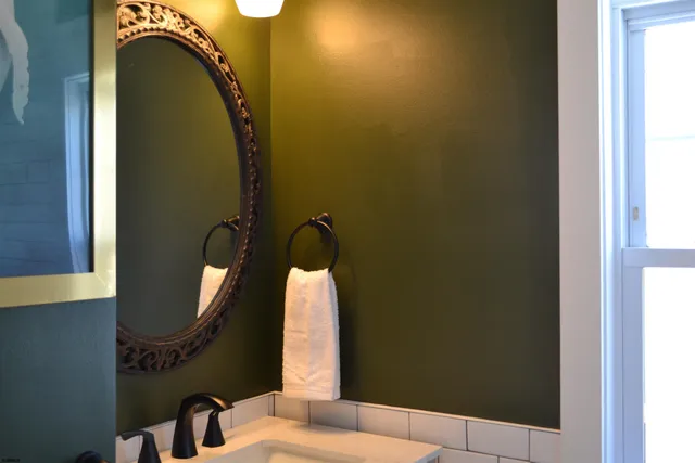 a bathroom with a mirror and a shower