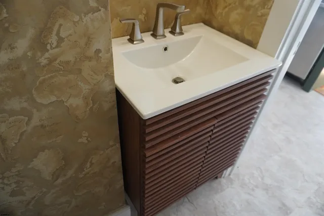 a bathroom with a sink and a mirror