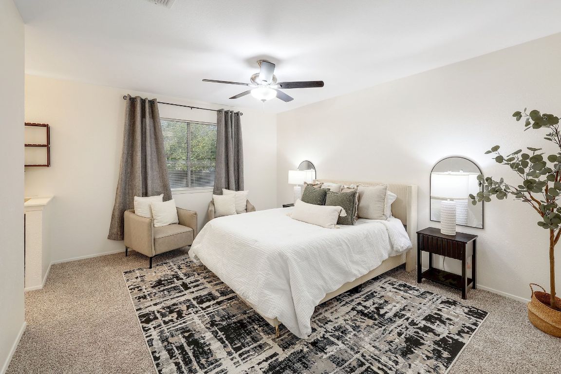 12511 Tree Line Drive Austin, TX 78729 - Photo 15 of 19 a bedroom with a large bed and a chandelier