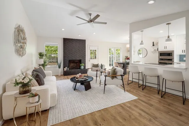 a living room with fireplace furniture and a wooden floor