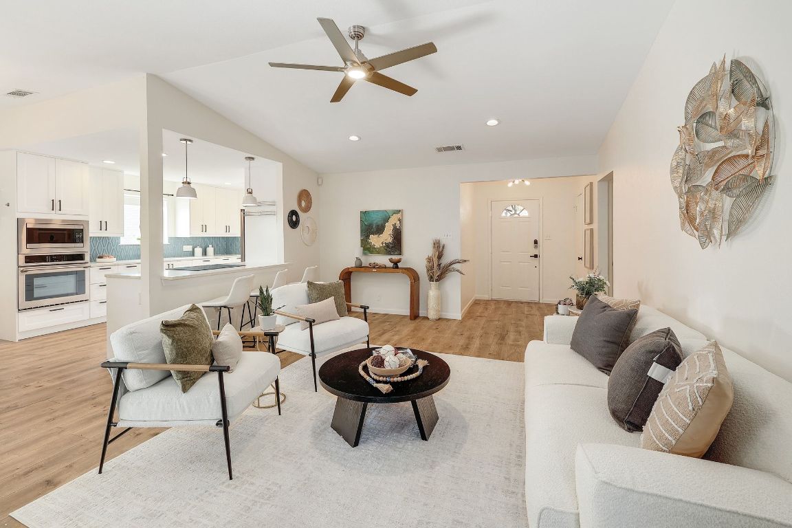 12511 Tree Line Drive Austin, TX 78729 - Photo 9 of 19 a living room with furniture a rug and a ceiling fan