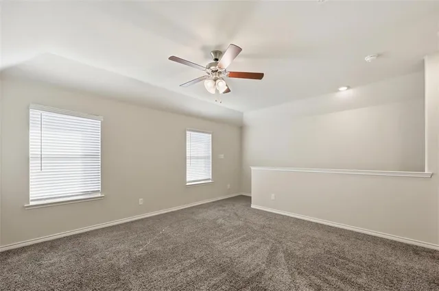 a view of a livingroom with a ceiling fan and window