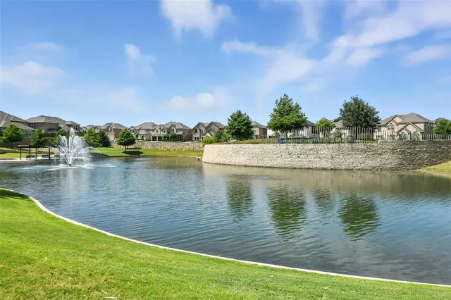 a view of a lake with houses in the back