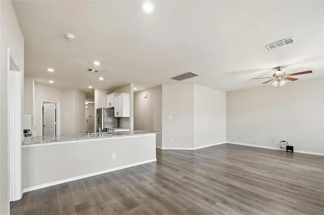 a large kitchen with a sink dishwasher a refrigerator and a fireplace