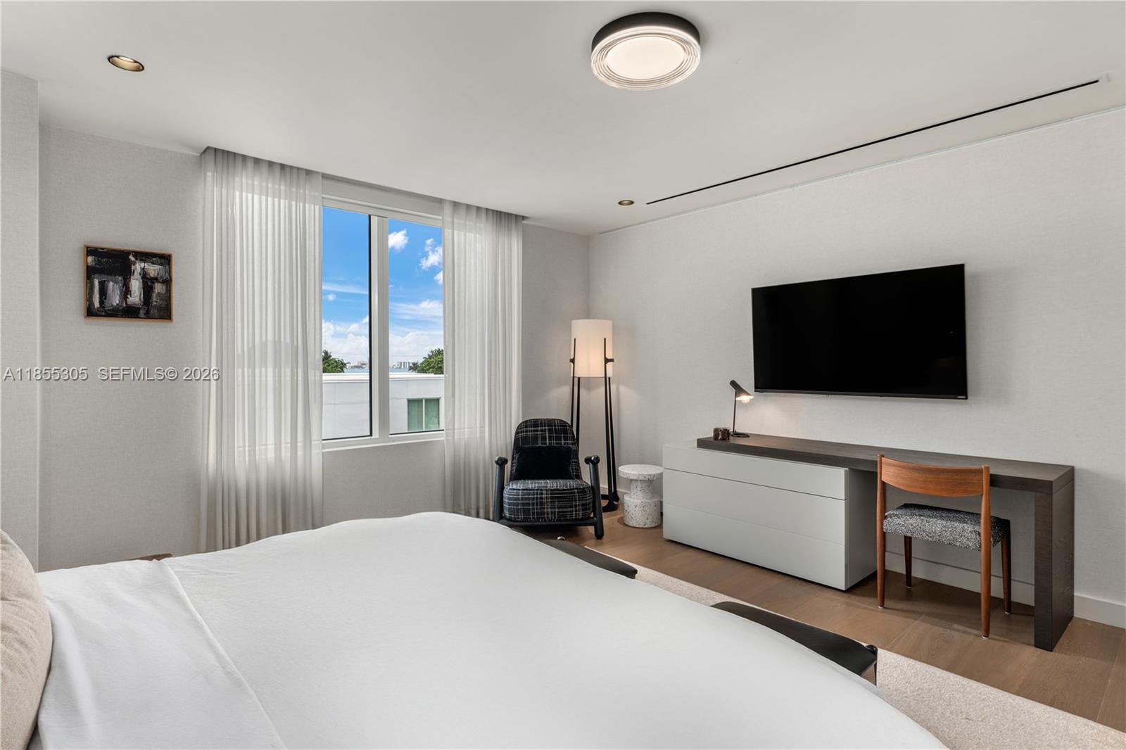 4701 Meridian Avenue, Unit 421 Miami Beach, FL 33140 - Photo 16 of 40 a bedroom with a bed and a flat screen tv