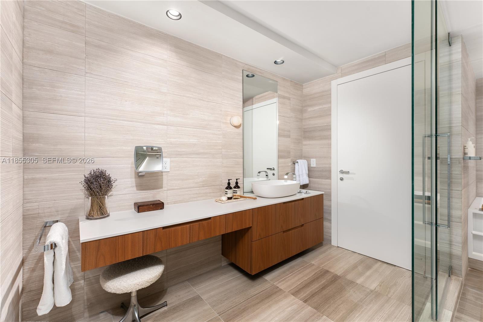 4701 Meridian Avenue, Unit 421 Miami Beach, FL 33140 - Photo 26 of 40 a bathroom with a double vanity sink mirror and toilet