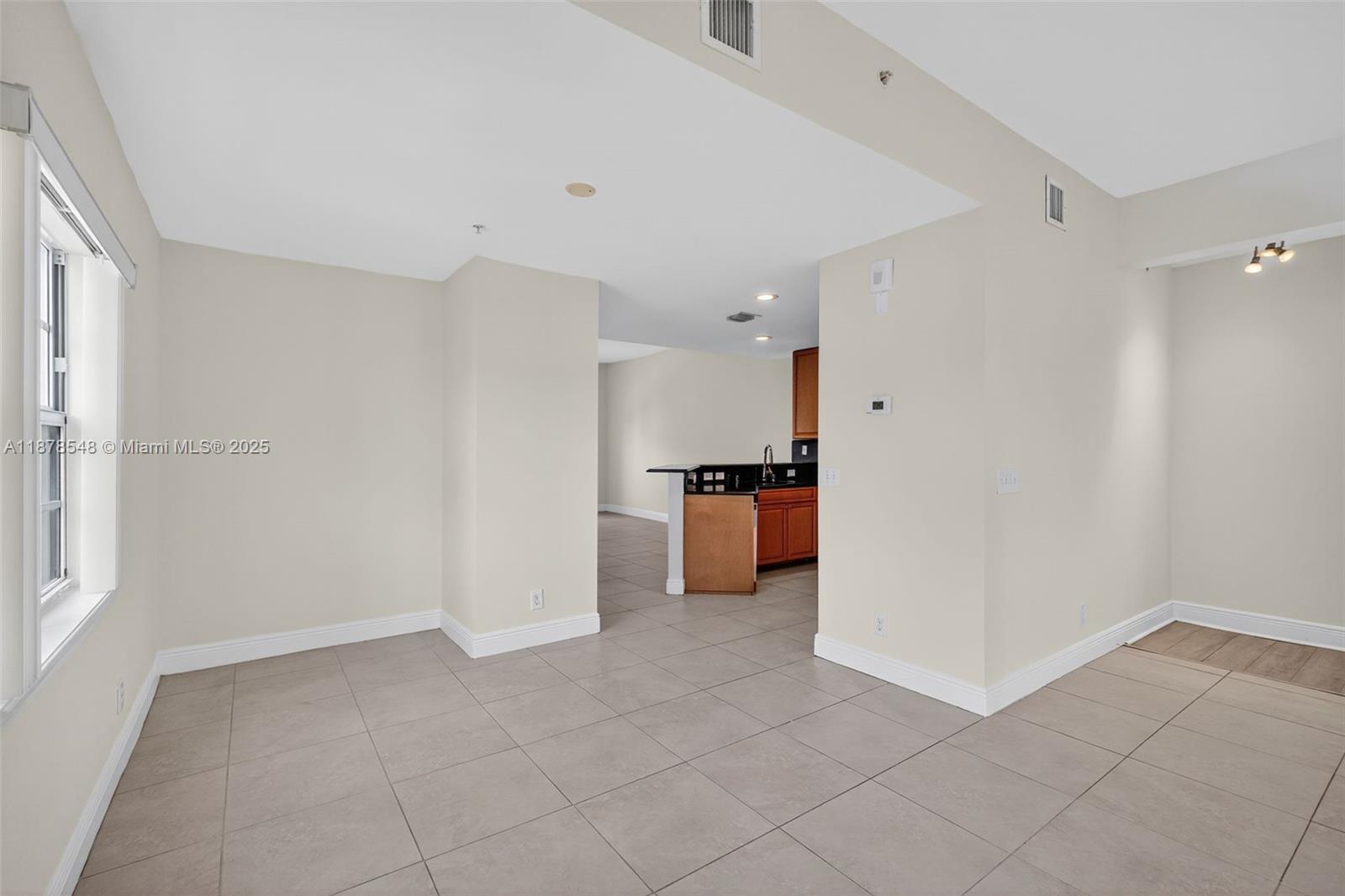 27 Southwest 6th Court Pompano Beach, FL 33060 - Photo 12 of 70 a view of a kitchen with a sink and a refrigerator