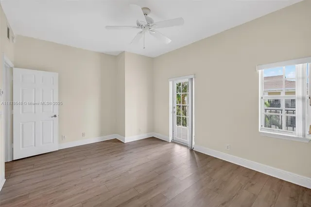 a view of hallway with wooden floor