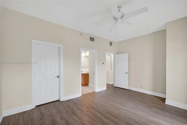 a view of washer and dryer with bathroom in the background