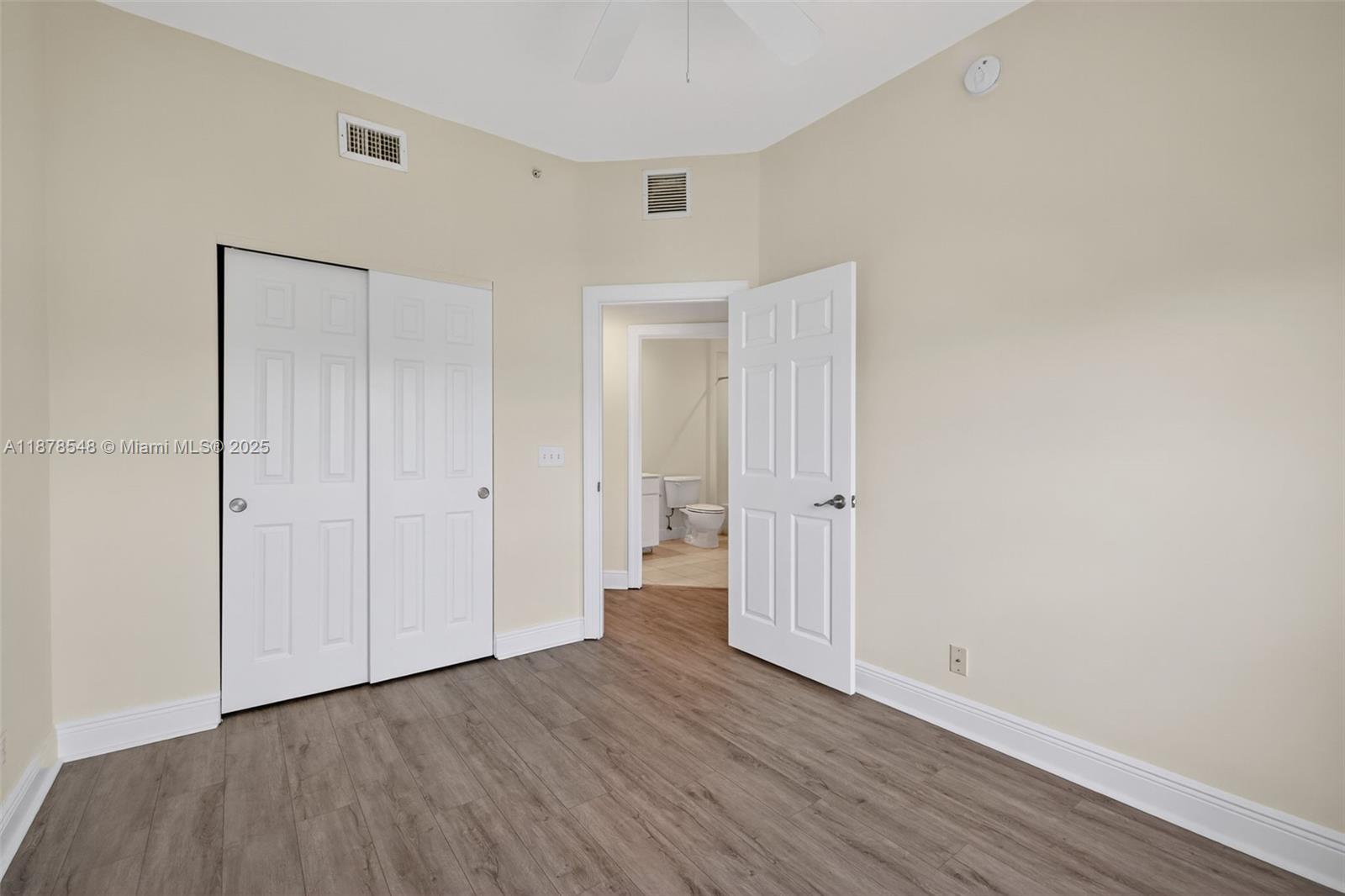 27 Southwest 6th Court Pompano Beach, FL 33060 - Photo 32 of 70 a view of an empty room with wooden floor