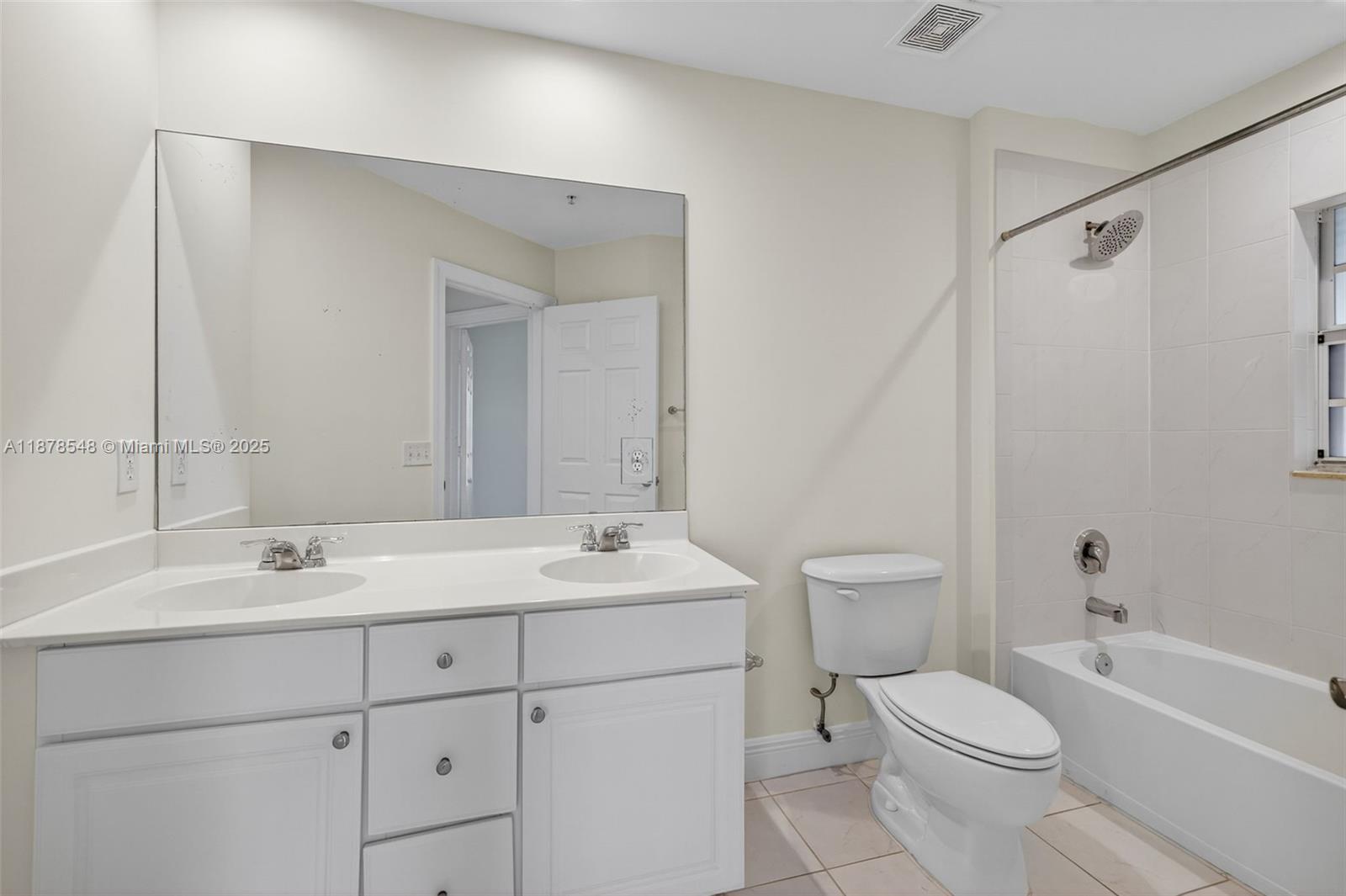 27 Southwest 6th Court Pompano Beach, FL 33060 - Photo 33 of 70 a bathroom with a toilet a sink a mirror a bathtub and vanity