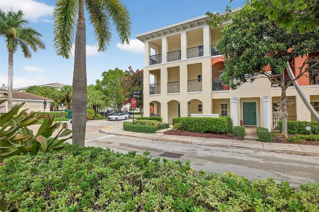a couple of cars parked in front of a building