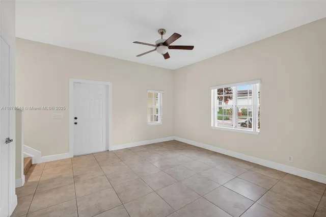 a front view of a house with a garden and trees