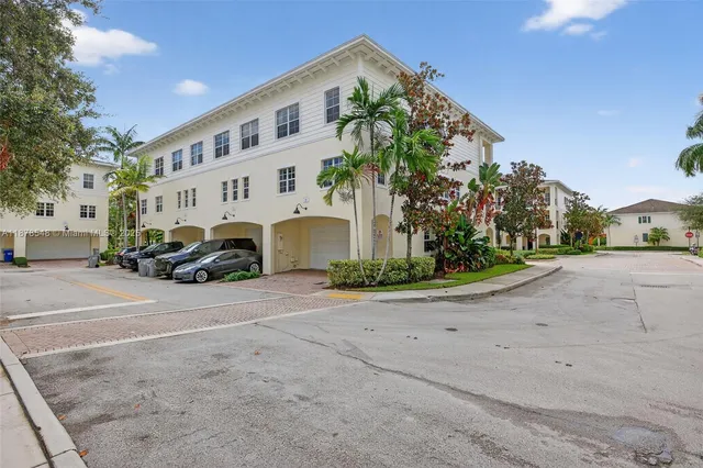 an aerial view of a house with a yard and sitting area