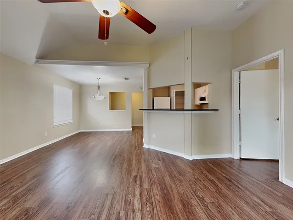 a view of a kitchen with wooden floor