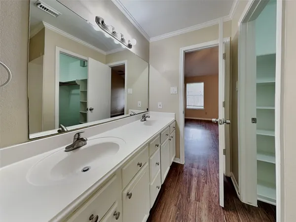 a spacious bathroom with double vanity and a mirror