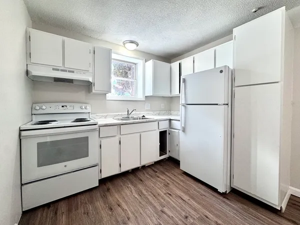 a kitchen with a white cabinets and white appliances