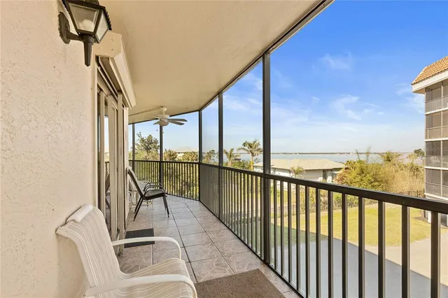 a spacious bedroom with a bed a chandelier and a window
