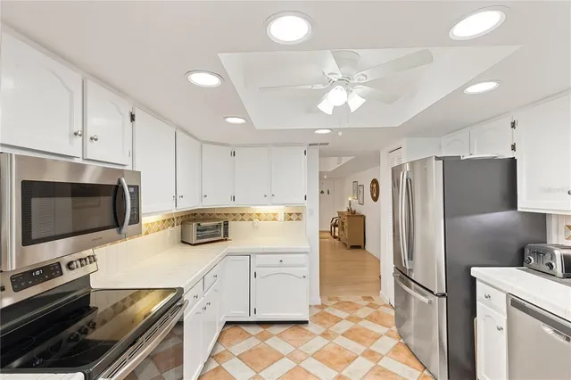 a kitchen with stainless steel appliances a refrigerator sink and microwave