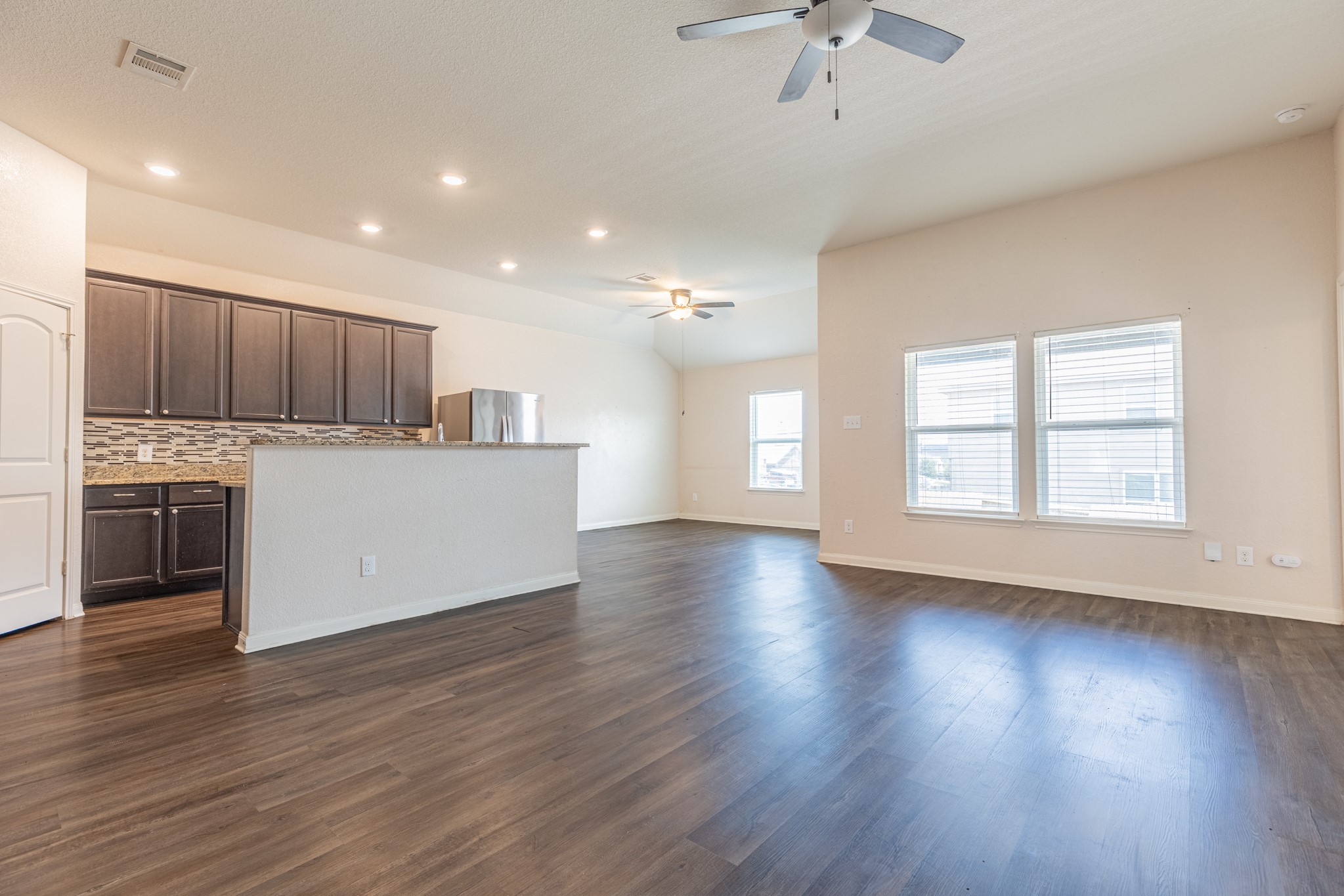 20017 Hubert R Humphrey Road Manor, TX 78653 - Photo 11 of 35 An open-concept layout unites the kitchen and living space, offering generous room for daily living.