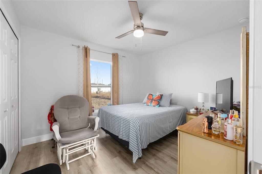 3597 Southwest 151st Avenue Ocala, FL 34481 - Photo 25 of 35 a bedroom with a bed and a chair