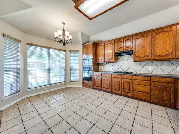a spacious bathroom with a granite countertop sink and a mirror