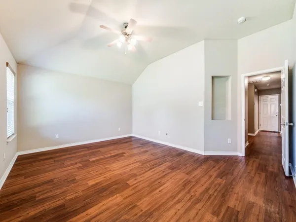 wooden floor in an empty room with a window