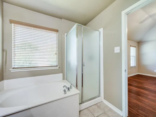 a bathroom with a bathtub and a shower