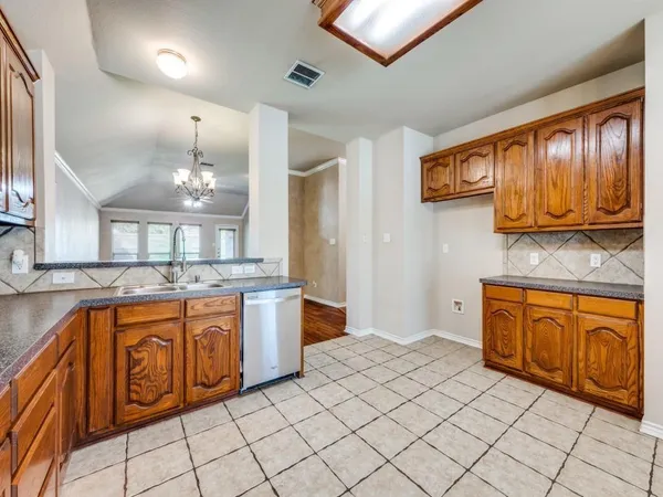 a large kitchen with stainless steel appliances granite countertop a sink and cabinets