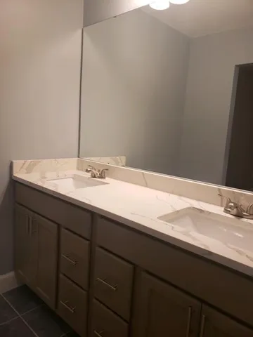 a bathroom with a sink and a mirror