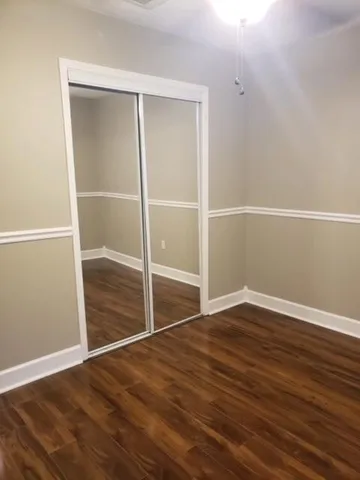an empty room with wooden floor