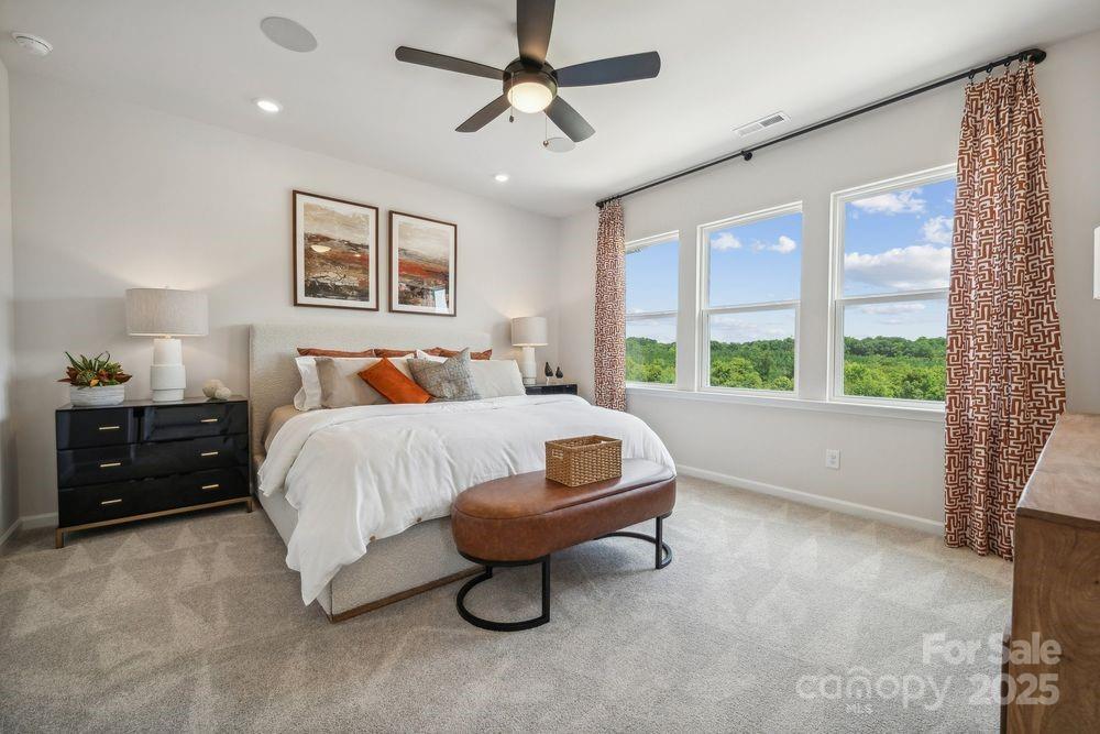 a bedroom with a bed and a large window