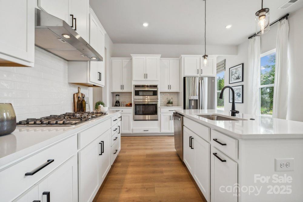3150 Beacon Hts Road Indian Land, SC 29707 - Photo 12 of 28 a large kitchen with stainless steel appliances sink a stove and cabinets