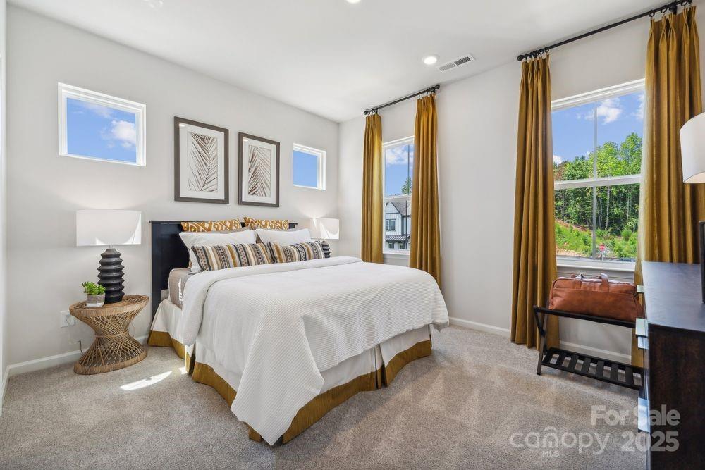 3150 Beacon Hts Road Indian Land, SC 29707 - Photo 15 of 28 a spacious bedroom with a bed and a large window