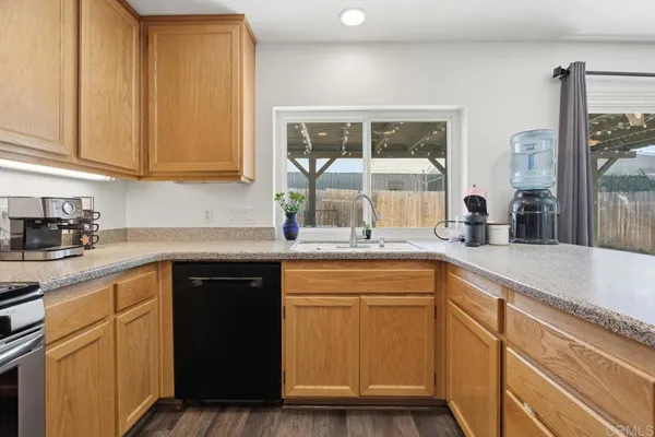 a kitchen with granite countertop white cabinets and white appliances