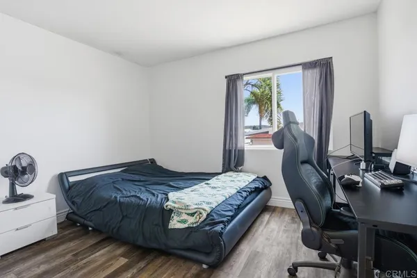 a bedroom with a bed chair and a window