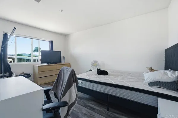 a bedroom with furniture and a window