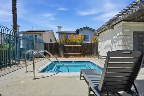 a view of a patio with a table and chairs