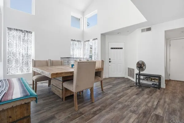 a view of a dining room with furniture and wooden floor