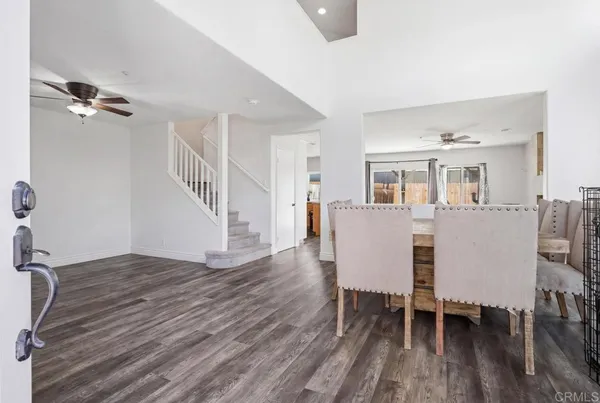 a view of a dining room with furniture and wooden floor
