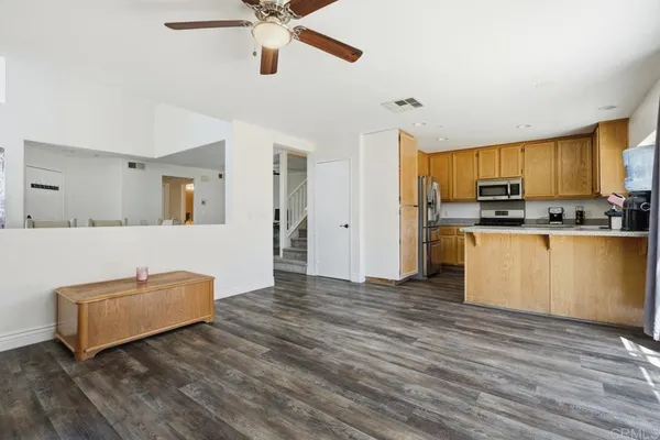 a view of kitchen with stainless steel appliances granite countertop a stove and a refrigerator