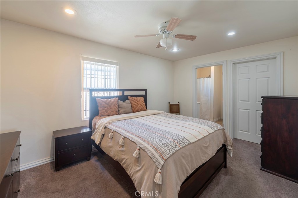 2734 West Caldwell Street Compton, CA 90220 - Photo 14 of 39 a bedroom with a bed and a chandelier