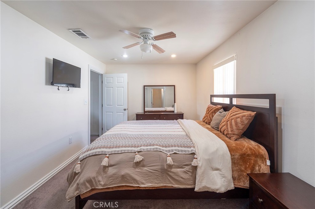 2734 West Caldwell Street Compton, CA 90220 - Photo 15 of 39 a bedroom with a bed and a tv