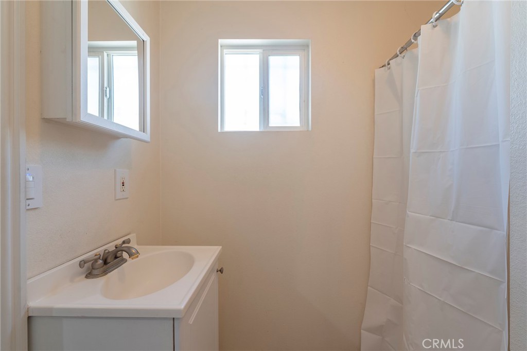 2734 West Caldwell Street Compton, CA 90220 - Photo 16 of 39 a bathroom with a sink and a mirror