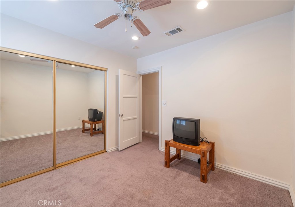2734 West Caldwell Street Compton, CA 90220 - Photo 22 of 39 an empty room with windows and ceiling fan
