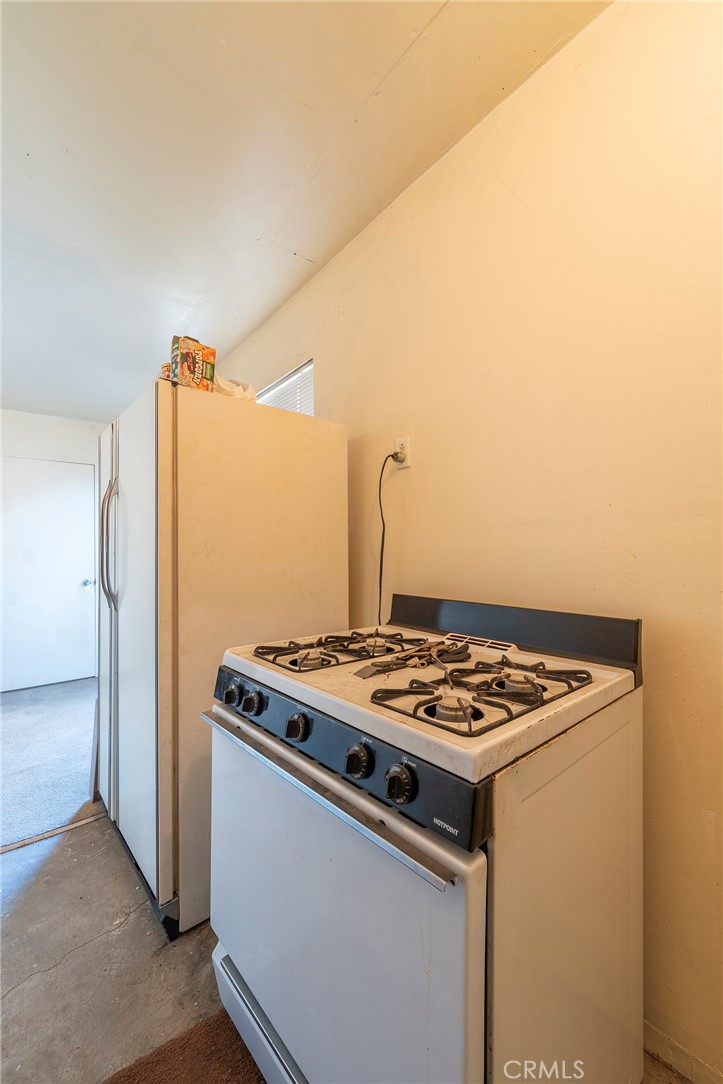 2734 West Caldwell Street Compton, CA 90220 - Photo 33 of 39 a kitchen with stainless steel appliances granite countertop a stove and a refrigerator