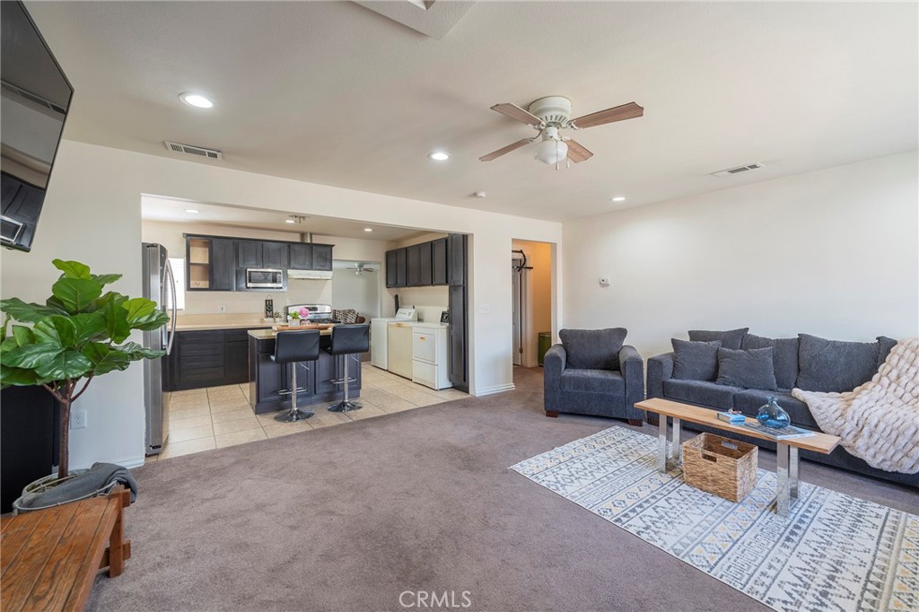 2734 West Caldwell Street Compton, CA 90220 - Photo 4 of 39 a living room with furniture and a potted plant