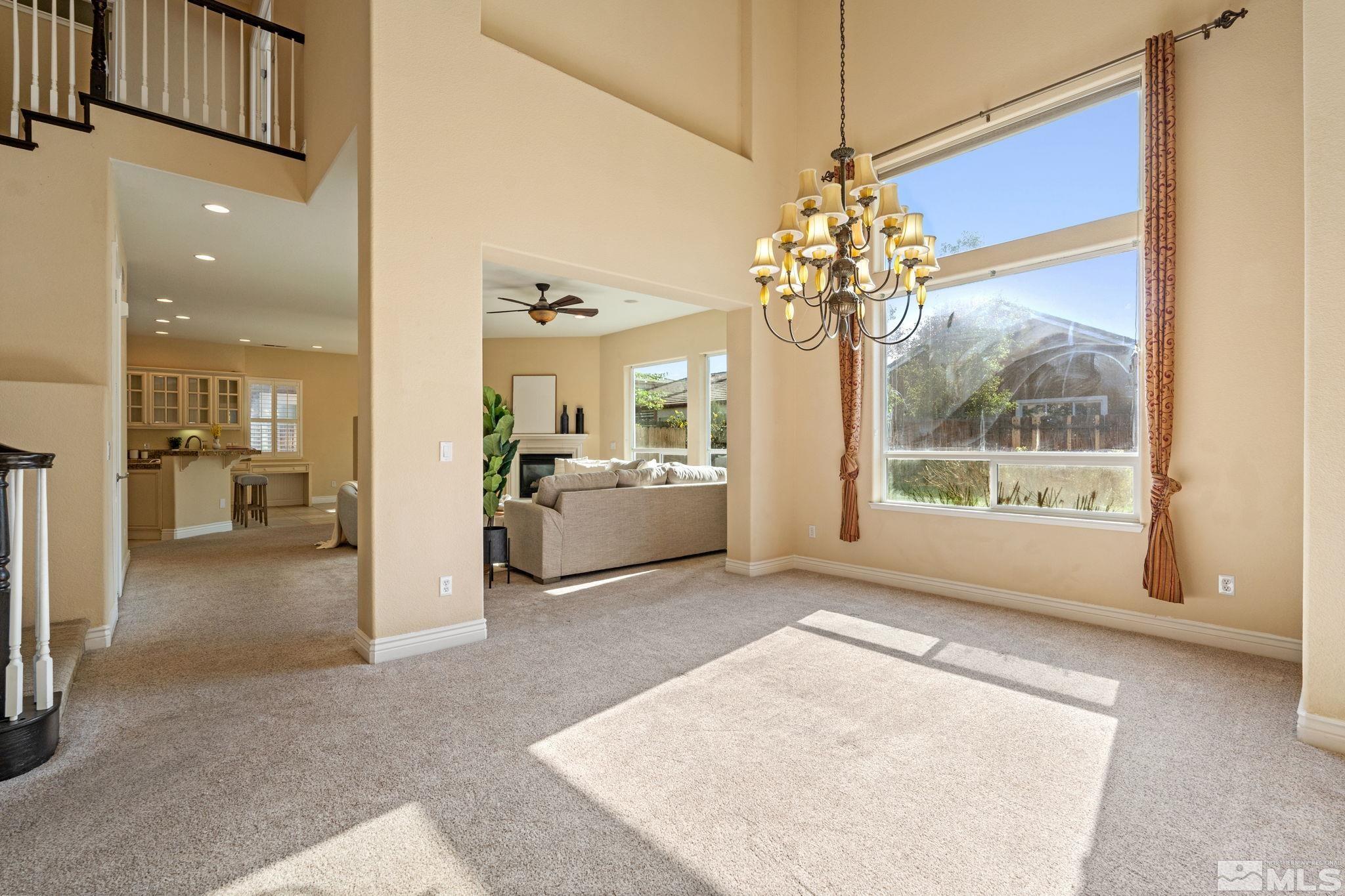 10035 Goler Wash Court Reno, NV 89521 - Photo 11 of 40 a view of a big room with chandelier and windows