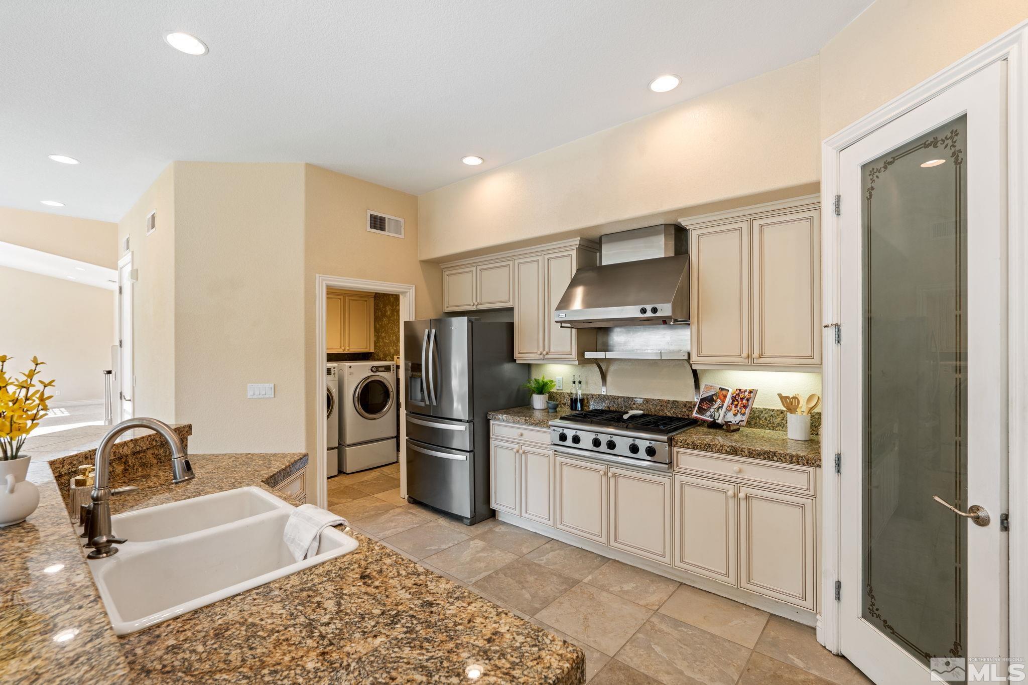 10035 Goler Wash Court Reno, NV 89521 - Photo 21 of 40 a kitchen with stainless steel appliances granite countertop a refrigerator stove top oven and sink